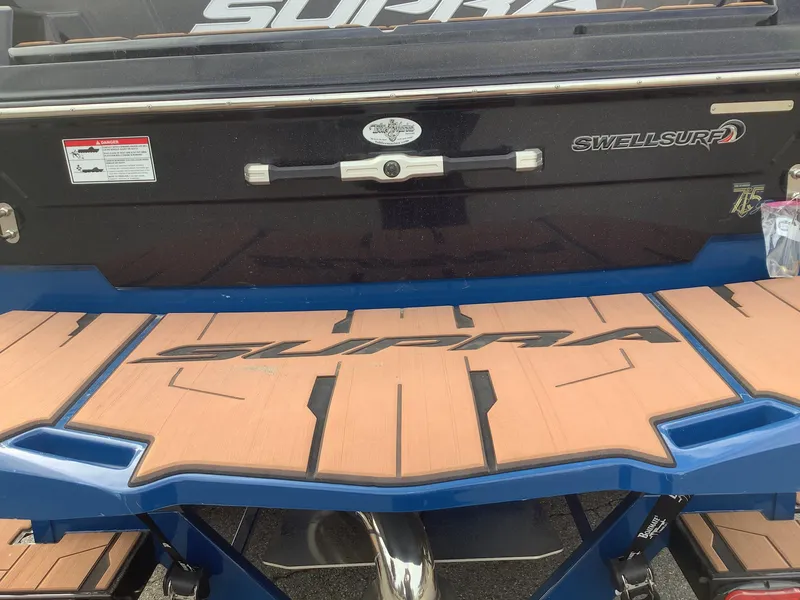 Slide: The Image of 2023 Supra SE boat on trailer under cloudy sky. - 10
