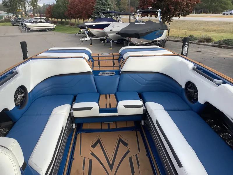 Slide: The Image of Rear view of a 2023 Supra SE boat on a parking lot. - 12