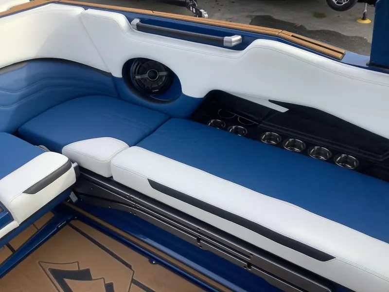 Slide: The Image of 2023 Supra SE interior with blue and white seating. - 13
