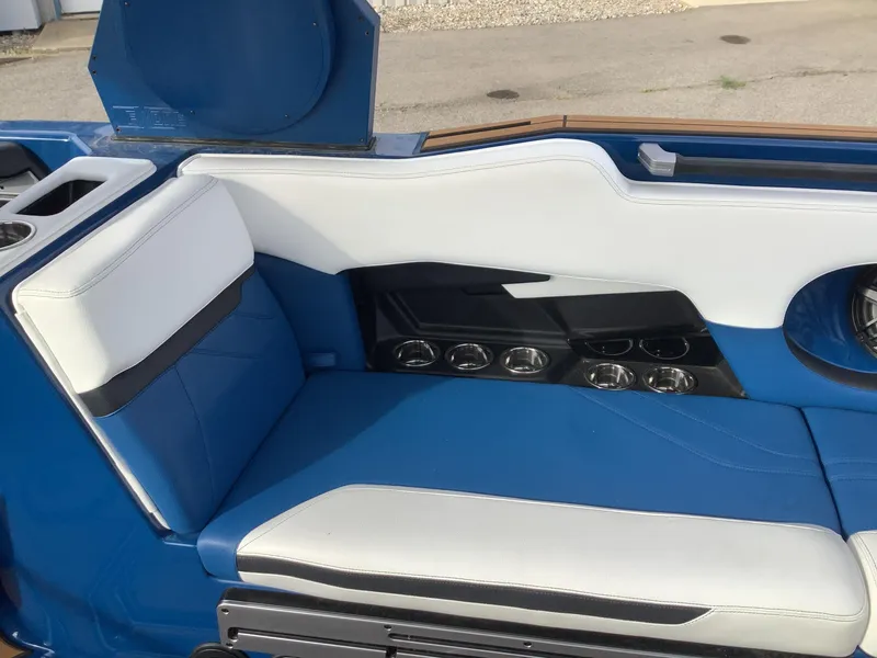 Slide: The Image of 2023 Supra SE boat with open storage hatch on parking lot. - 16