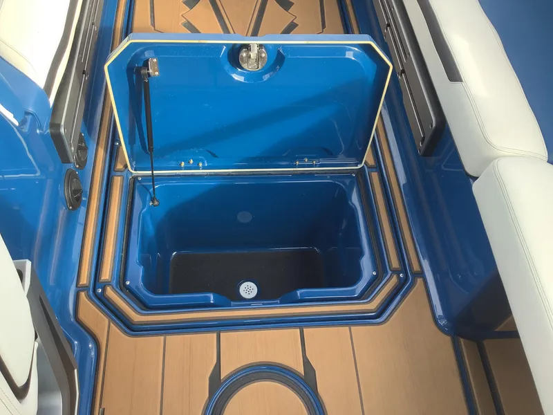 Slide: The Image of 2023 Supra SE boat with blue and white seating and table. - 18