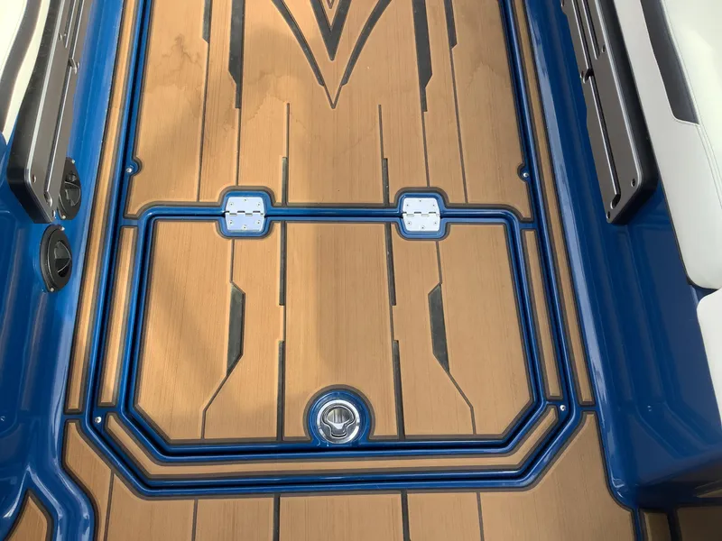 Slide: The Image of Interior of a 2023 Supra SE boat with blue and white seating. - 19