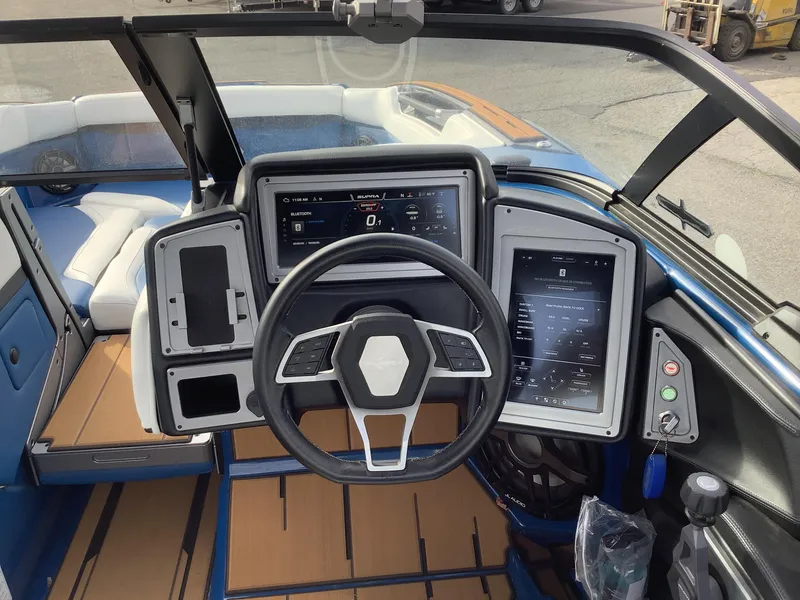 Slide: The Image of 2023 Supra SE boat with open storage hatch on a parking lot. - 20
