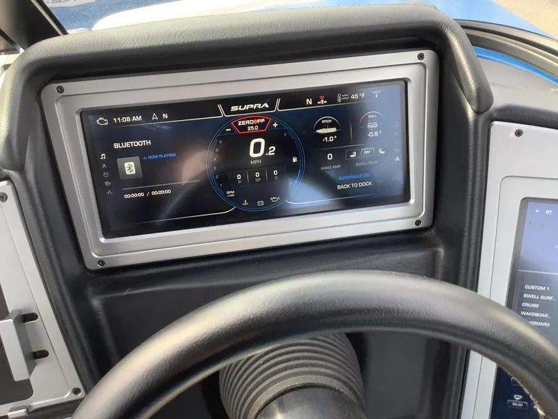 Slide: The Image of Interior of a 2023 Supra SE boat with blue and white seating. - 21