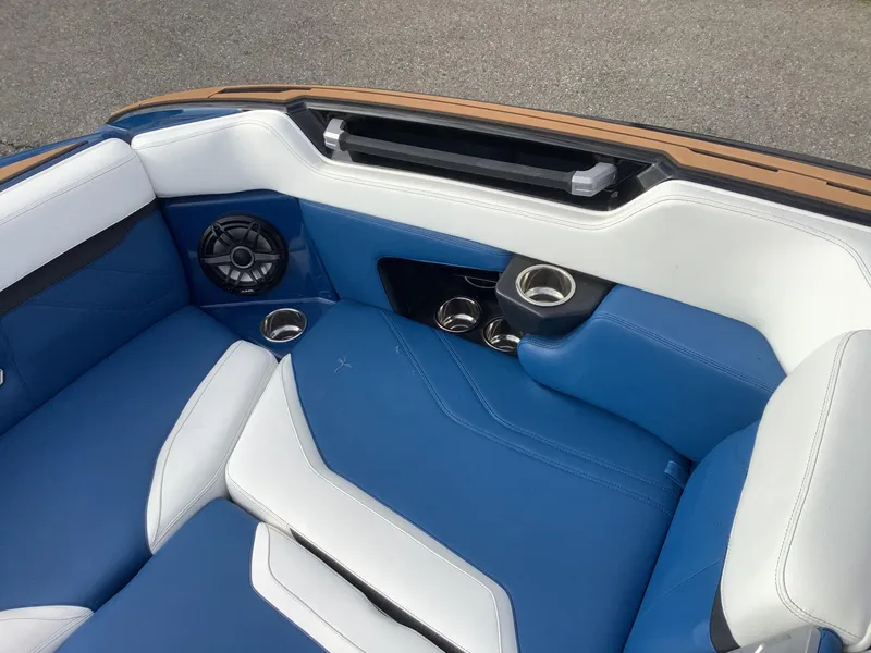 Slide: The Image of 2023 Supra SE boat hatch with storage and blue trim. - 24