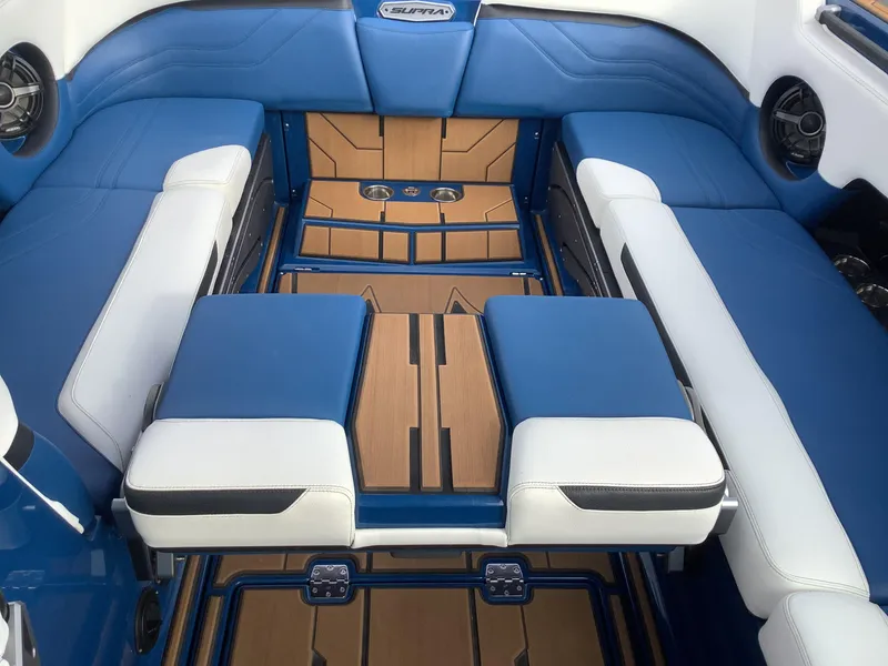 Slide: The Image of Interior of a 2023 Supra SE with blue and white seating. - 28