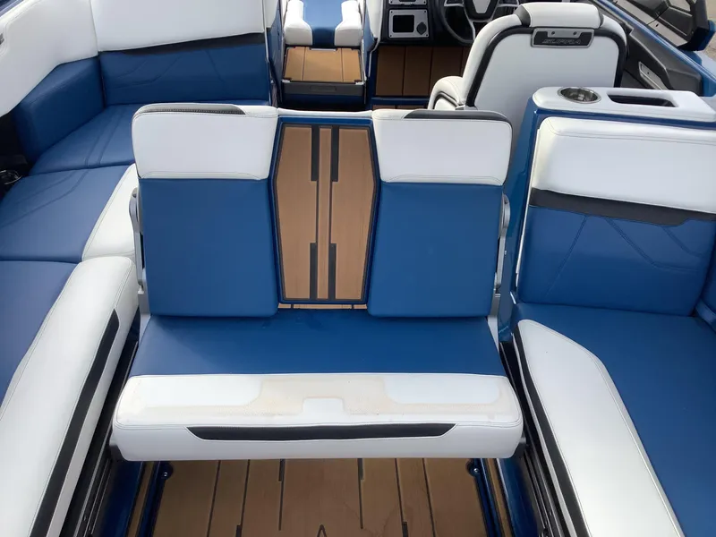 Slide: The Image of Interior of a 2023 Supra SE boat with blue and white seating. - 30