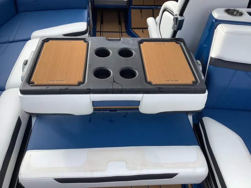 Slide: The Image of 2023 Supra SE boat with open storage compartment and blue interior. - 31