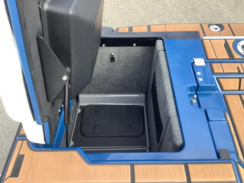 Slide: The Image of Interior of a 2023 Supra SE boat with blue and white seating. - 35