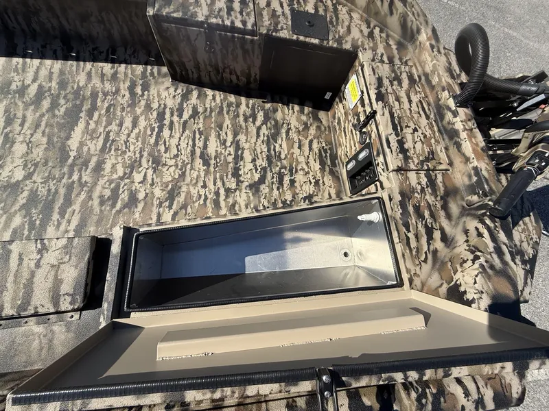 Slide: The Image of 2025 Excel Viper F4 1751 boat interior with camo design and storage compartment. - 10