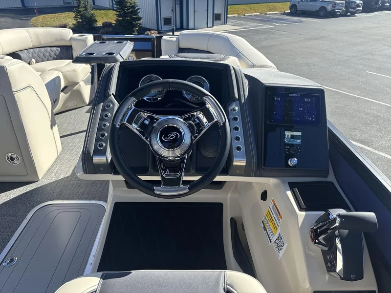 Slide: The Image of 2025 Barletta Lusso L23UC boat dashboard with steering wheel and digital display. - 11