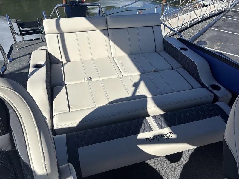 Slide: The Image of Luxurious seating on 2025 Barletta Lusso L23UC pontoon boat, featuring elegant upholstery and cup holders. - 14