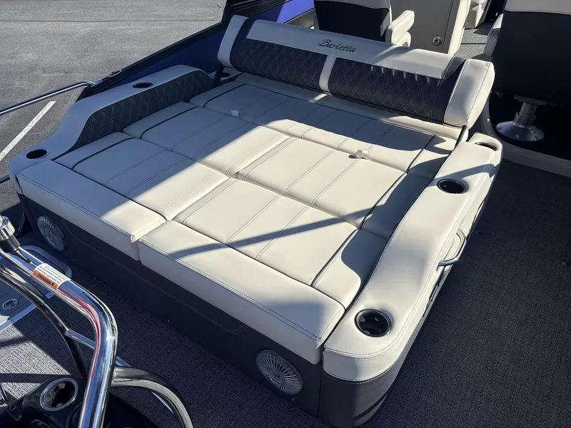 Slide: The Image of 2025 Barletta Lusso L23UC boat interior with luxurious seating and cup holders. - 15