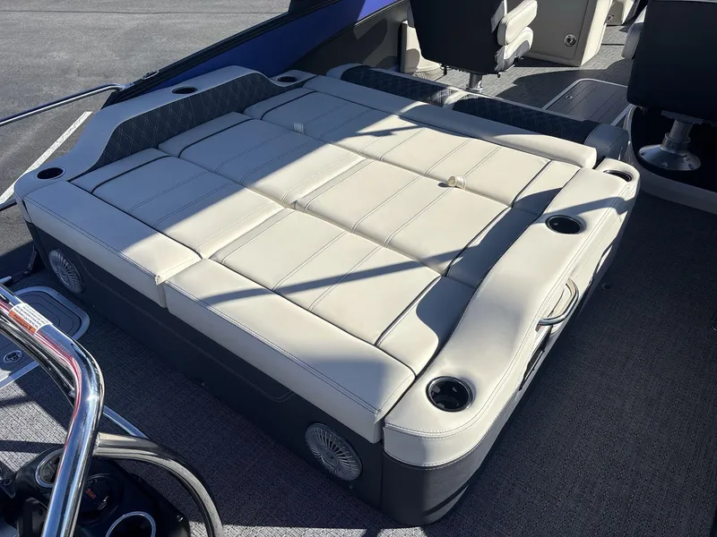 Slide: The Image of 2025 Barletta Lusso L23UC boat interior with luxurious seating and cup holders. - 16