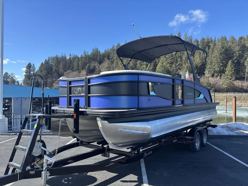 Slide: The Image of 2025 Barletta Lusso L23UC pontoon boat on trailer, parked near a lake. - 3