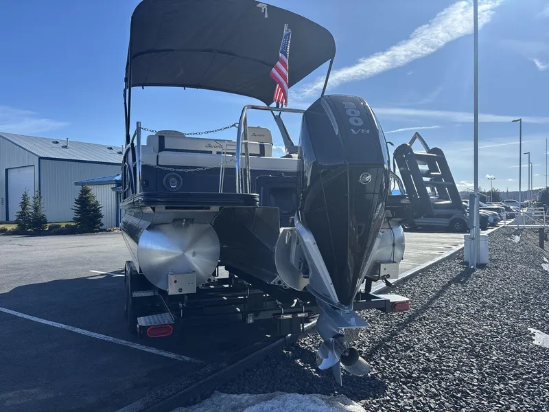 Slide: The Image of 2025 Barletta Lusso L23UC pontoon boat with powerful outboard motor in a parking lot. - 5