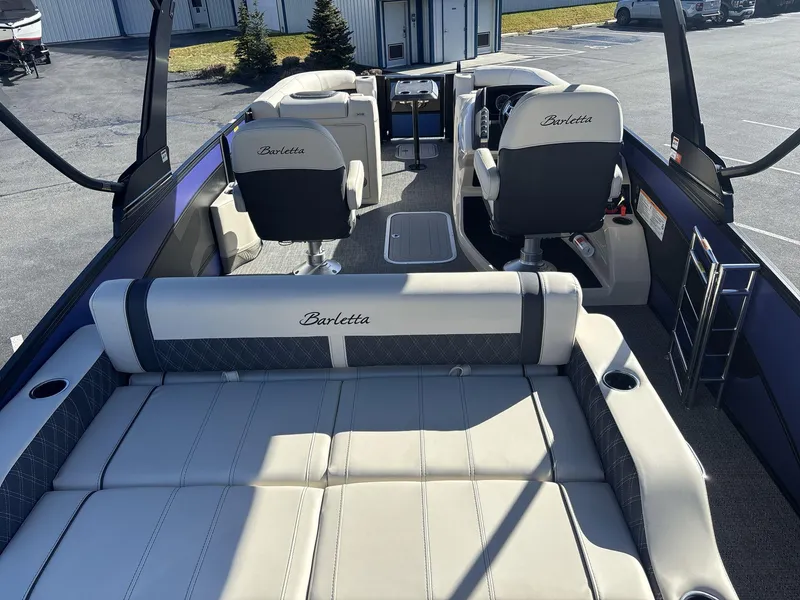 Slide: The Image of 2025 Barletta Lusso L23UC pontoon boat interior with luxurious seating and helm. - 6