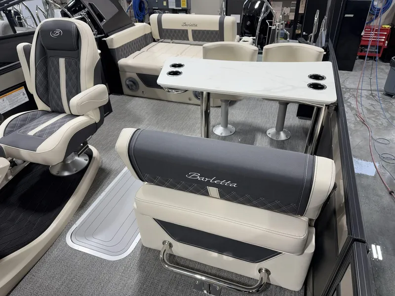 Slide: The Image of 2025 Barletta Lusso L25UEA interior with luxurious seating and table setup. - 14