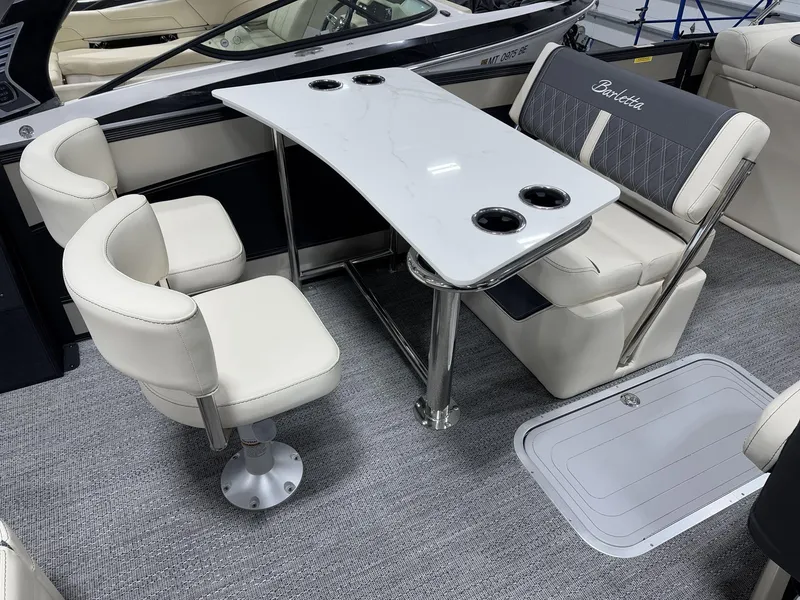 Slide: The Image of Interior of 2025 Barletta Lusso L25UEA boat with elegant seating and table setup. - 15