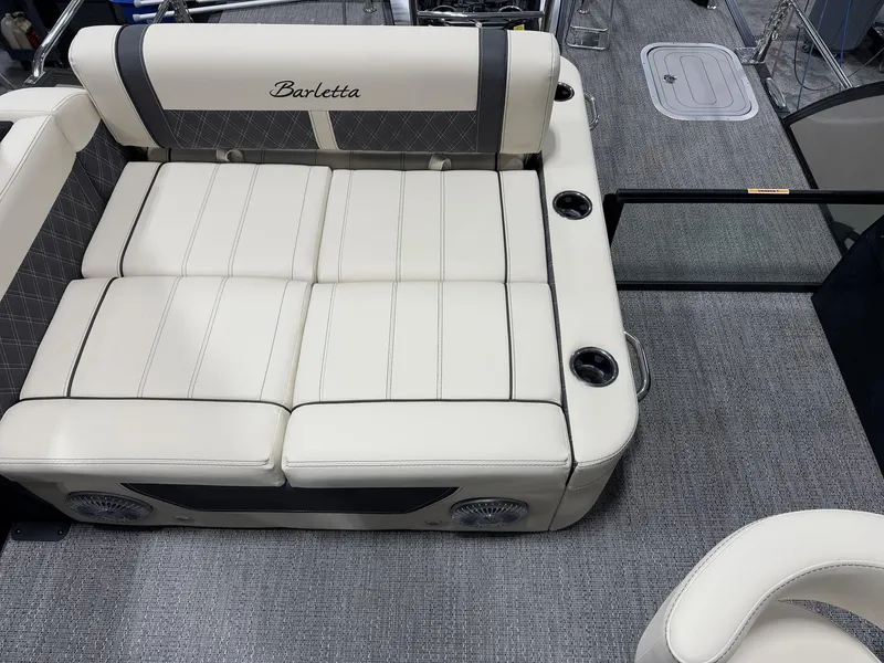 Slide: The Image of 2025 Barletta Lusso L25UEA boat interior with plush seating and cup holders. - 17