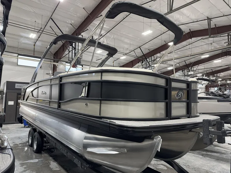 Slide: The Image of 2025 Barletta Lusso L25UEA pontoon boat in indoor showroom setting. - 3