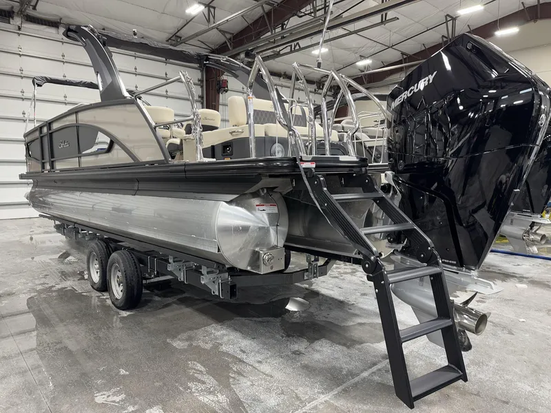 Slide: The Image of 2025 Barletta Lusso L25UEA pontoon boat with Mercury engine in a showroom. - 6