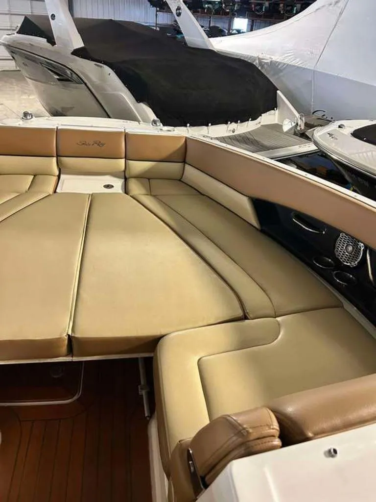 Slide: The Image of Luxurious seating area on a 2015 Sea Ray 350 SLX boat, featuring tan upholstery. - 10