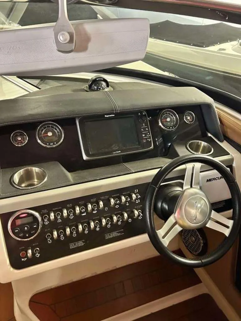 Slide: The Image of Dashboard of a 2015 Sea Ray 350 SLX boat with steering wheel and controls. - 11