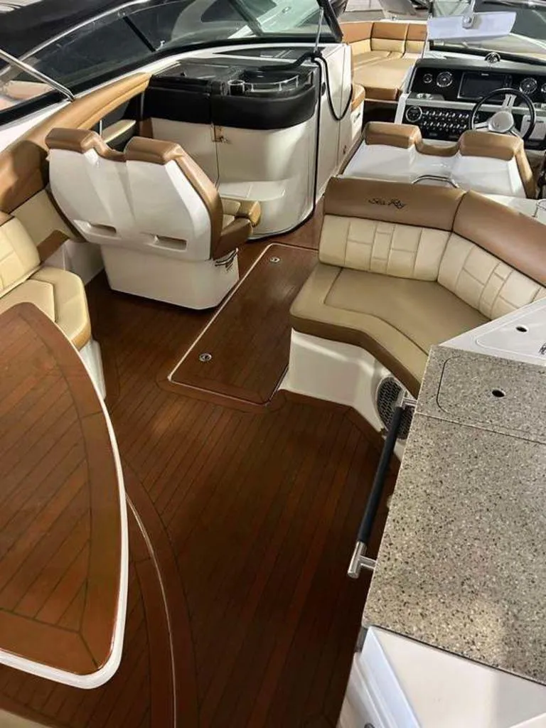 Slide: The Image of Luxurious interior of a 2015 Sea Ray 350 SLX boat with leather seating and wood flooring. - 12