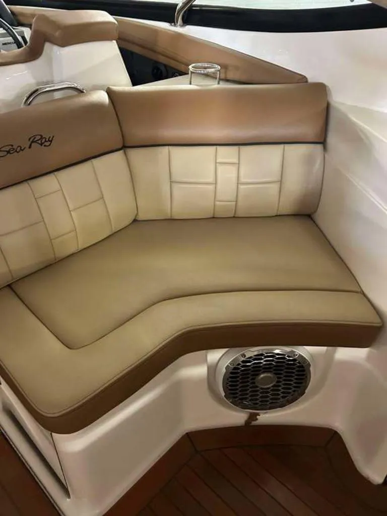 Slide: The Image of Luxurious seating on a 2015 Sea Ray 350 SLX boat with tan upholstery and speaker. - 13
