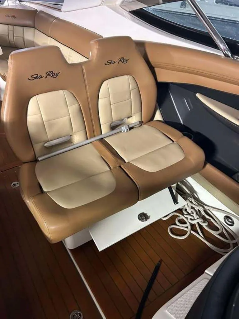 Slide: The Image of 2015 Sea Ray 350 SLX boat interior with tan leather seating and wood flooring. - 14