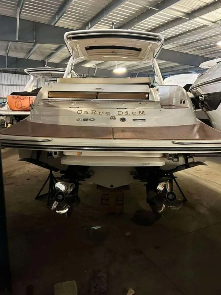 Slide: The Image of 2015 Sea Ray 350 SLX boat named "Carpe Diem" in a storage facility. - 3
