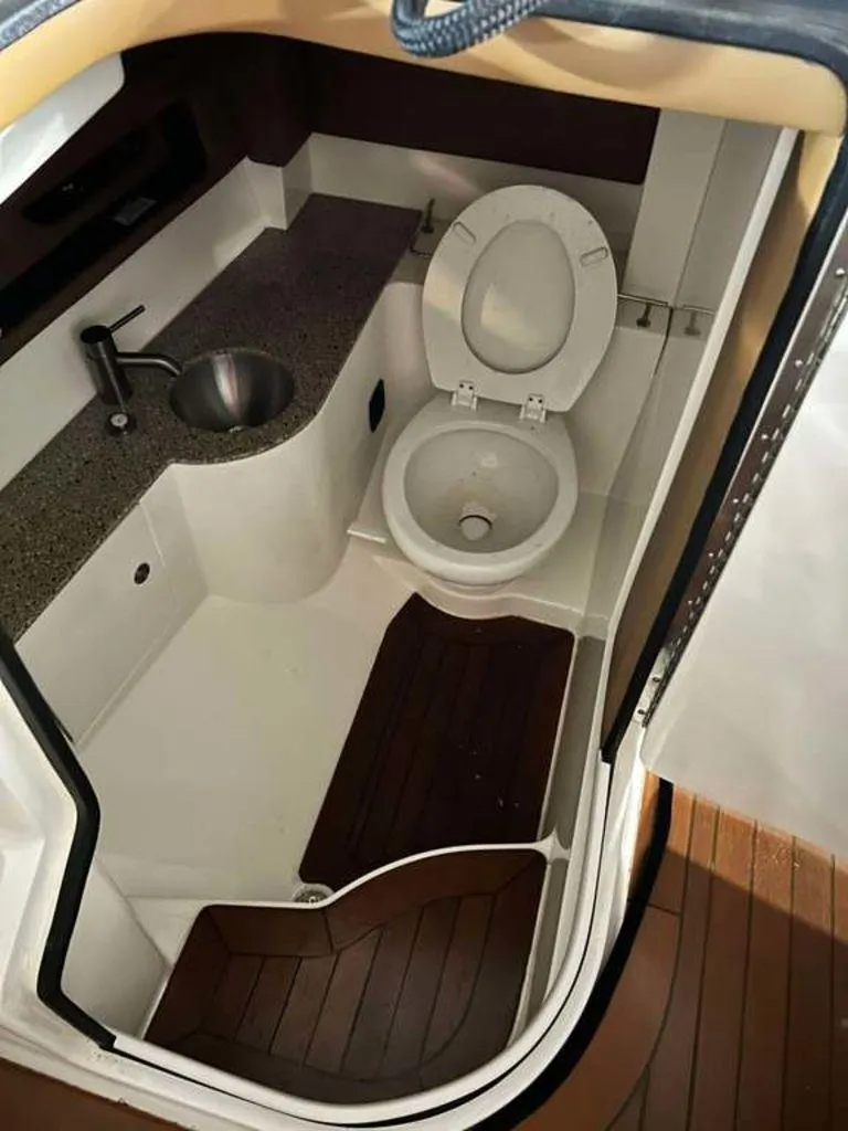 Slide: The Image of Interior of 2015 Sea Ray 350 SLX boat bathroom with toilet and sink. - 4