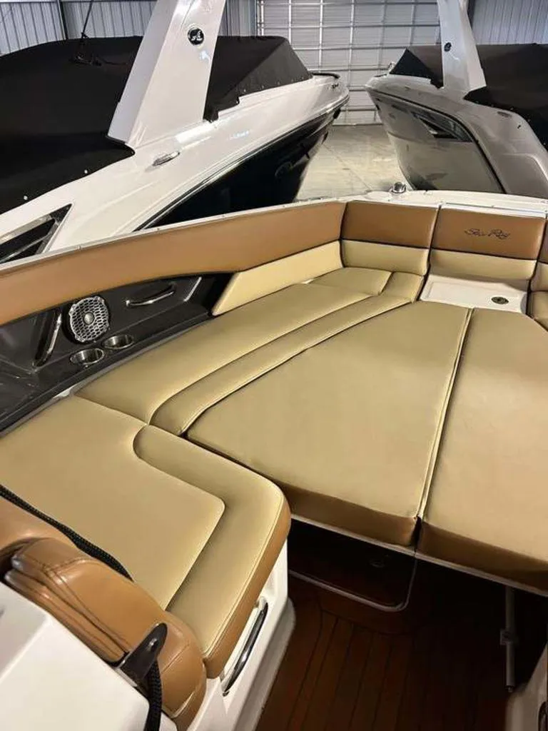 Slide: The Image of 2015 Sea Ray 350 SLX boat interior with tan leather seating in a showroom. - 7