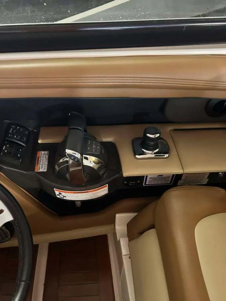 Slide: The Image of Interior controls of a 2015 Sea Ray 350 SLX boat, featuring throttle and joystick. - 8