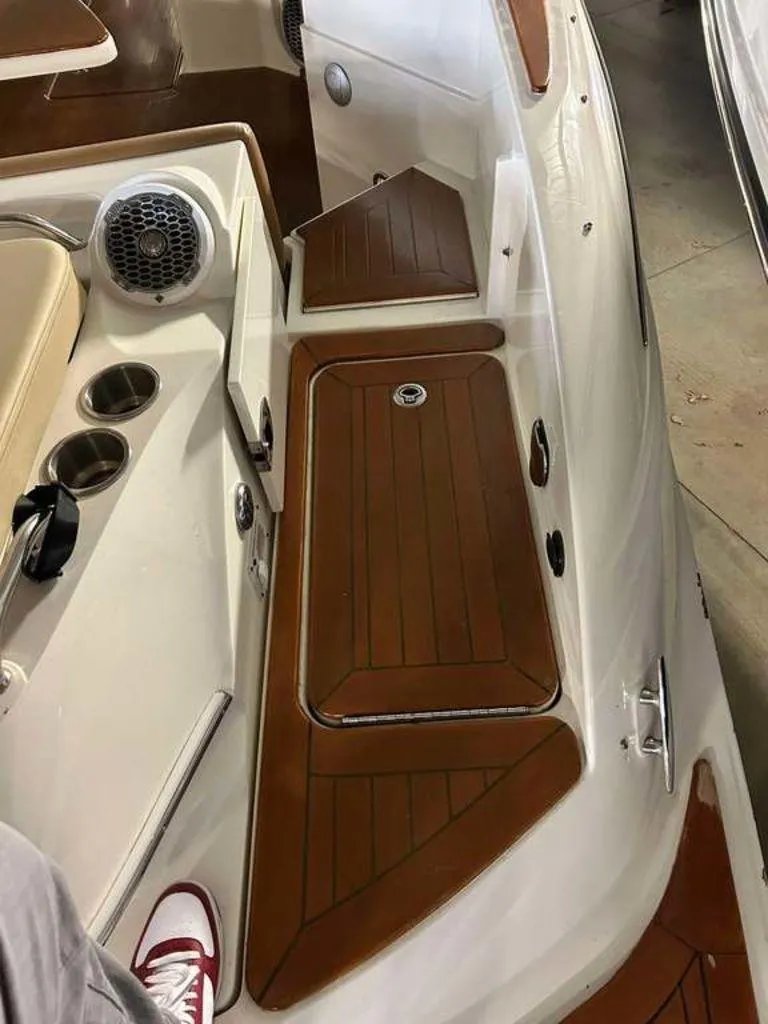 Slide: The Image of 2015 Sea Ray 350 SLX boat interior with wood accents and cup holders. - 9