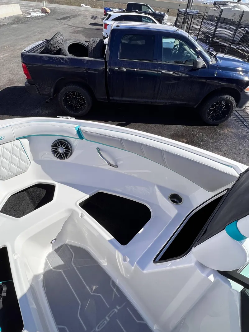 Slide: The Image of 2023 Regal 21 OBX boat interior with a pickup truck in the background. - 11