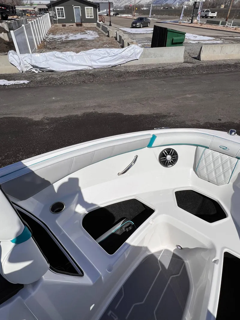 Slide: The Image of 2023 Regal 21 OBX boat interior with white seating and speaker. - 12