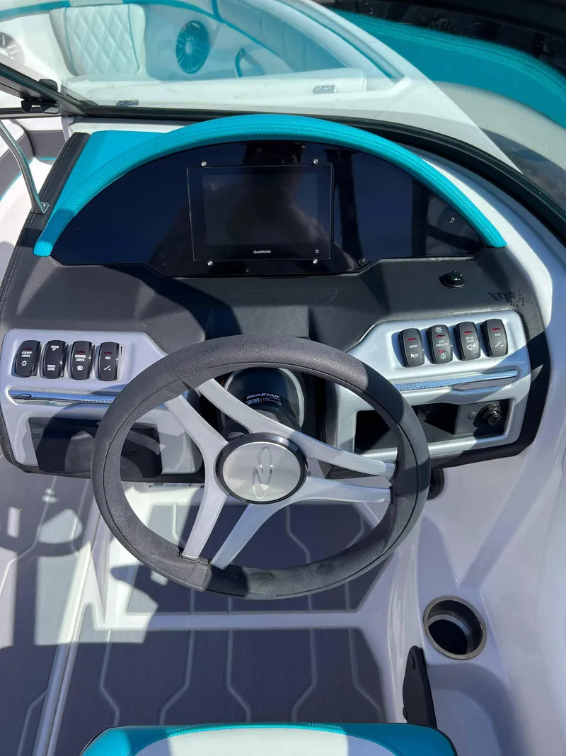 Slide: The Image of 2023 Regal 21 OBX boat dashboard with steering wheel and control panel. - 14