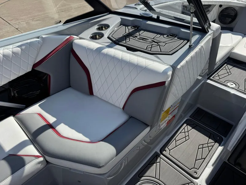 Slide: The Image of 2023 Tigé 22RZX boat interior with white and gray seating, red accents, and cup holders. - 14