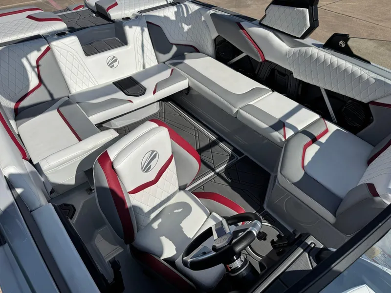 Slide: The Image of 2023 Tigé 22RZX boat interior with white and red upholstery, featuring a sleek steering wheel. - 15
