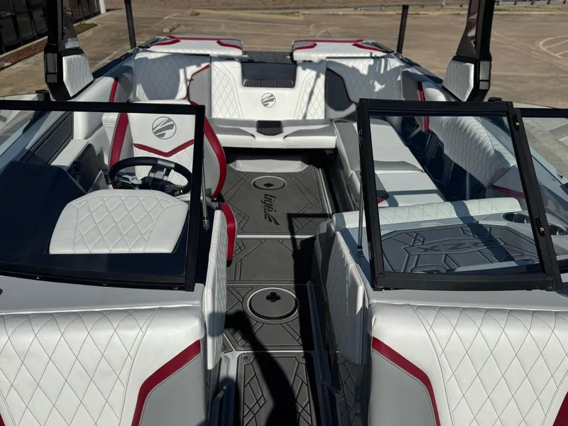Slide: The Image of 2023 Tigé 22RZX boat interior with white and red diamond-stitched seats. - 18