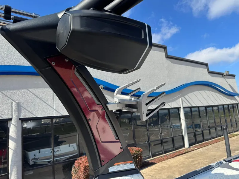 Slide: The Image of 2023 Tigé 22RZX boat tower with speaker and board rack, against a blue sky. - 20