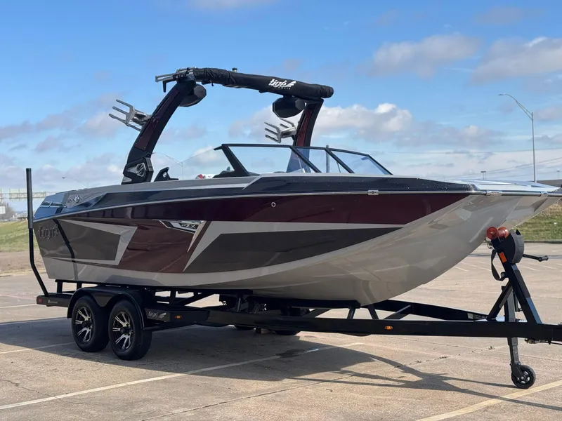 Slide: The Image of 2023 Tigé 22RZX boat on trailer, sleek design, parked outdoors. - 5