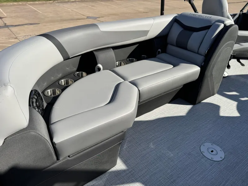 Slide: The Image of 2025 Trifecta 24RF CS 3.0 boat interior with gray seating and cup holders. - 6