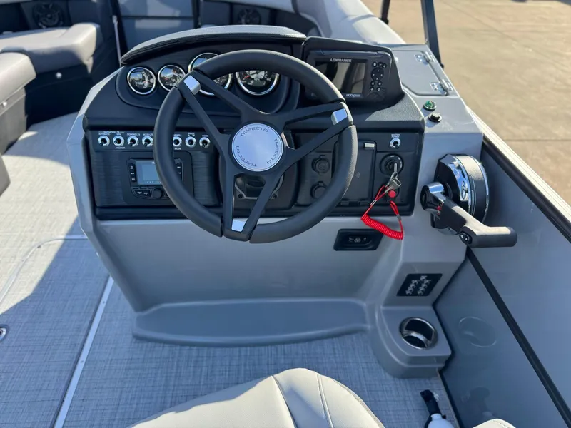 Slide: The Image of 2025 Trifecta 24RF CS 3.0 boat dashboard with steering wheel and controls. - 7