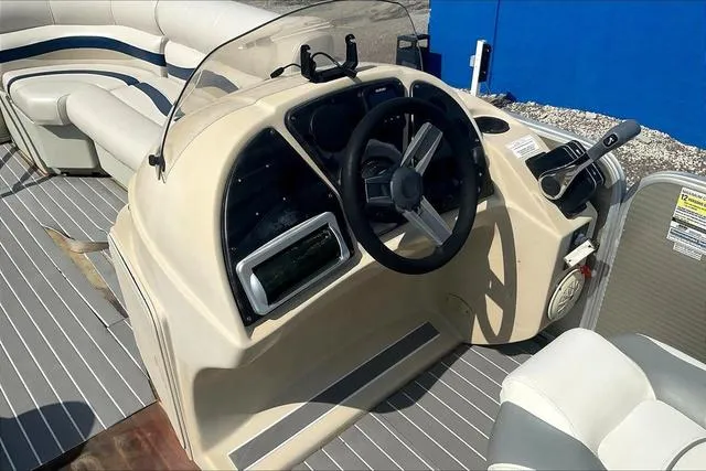 Slide: The Image of 2016 Sweetwater SW 2286 boat helm with steering wheel and control panel. - 13