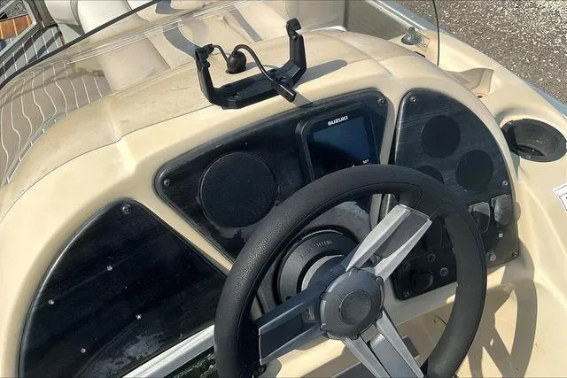 Slide: The Image of 2016 Sweetwater SW 2286 boat dashboard with steering wheel and control panel. - 17