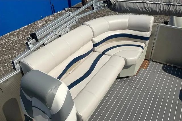 Slide: The Image of 2016 Sweetwater SW 2286 boat interior with white and blue cushioned seating. - 21