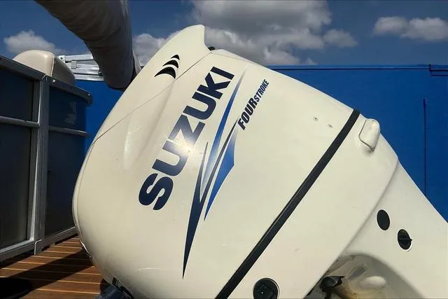 Slide: The Image of Suzuki Four Stroke outboard motor on 2016 Sweetwater SW 2286 boat, blue sky background. - 27